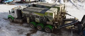 A large truck with two green tires on it.