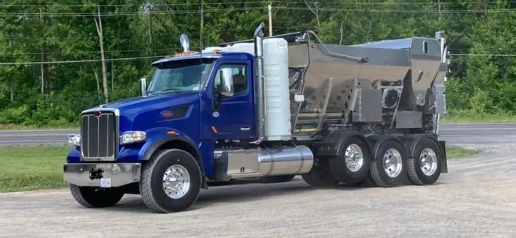 A blue truck is parked in the parking lot.