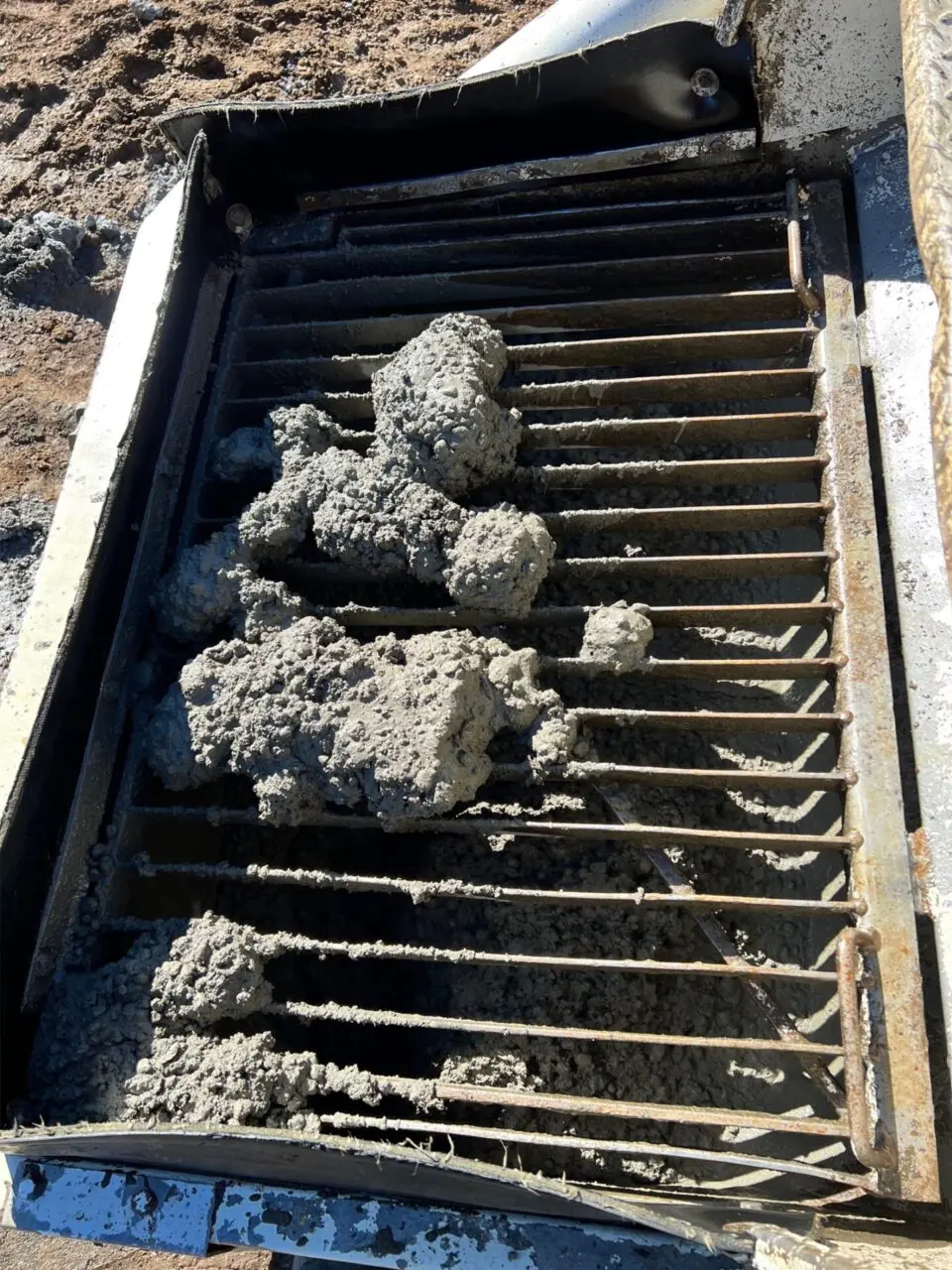 A pile of dirt on top of a train track.